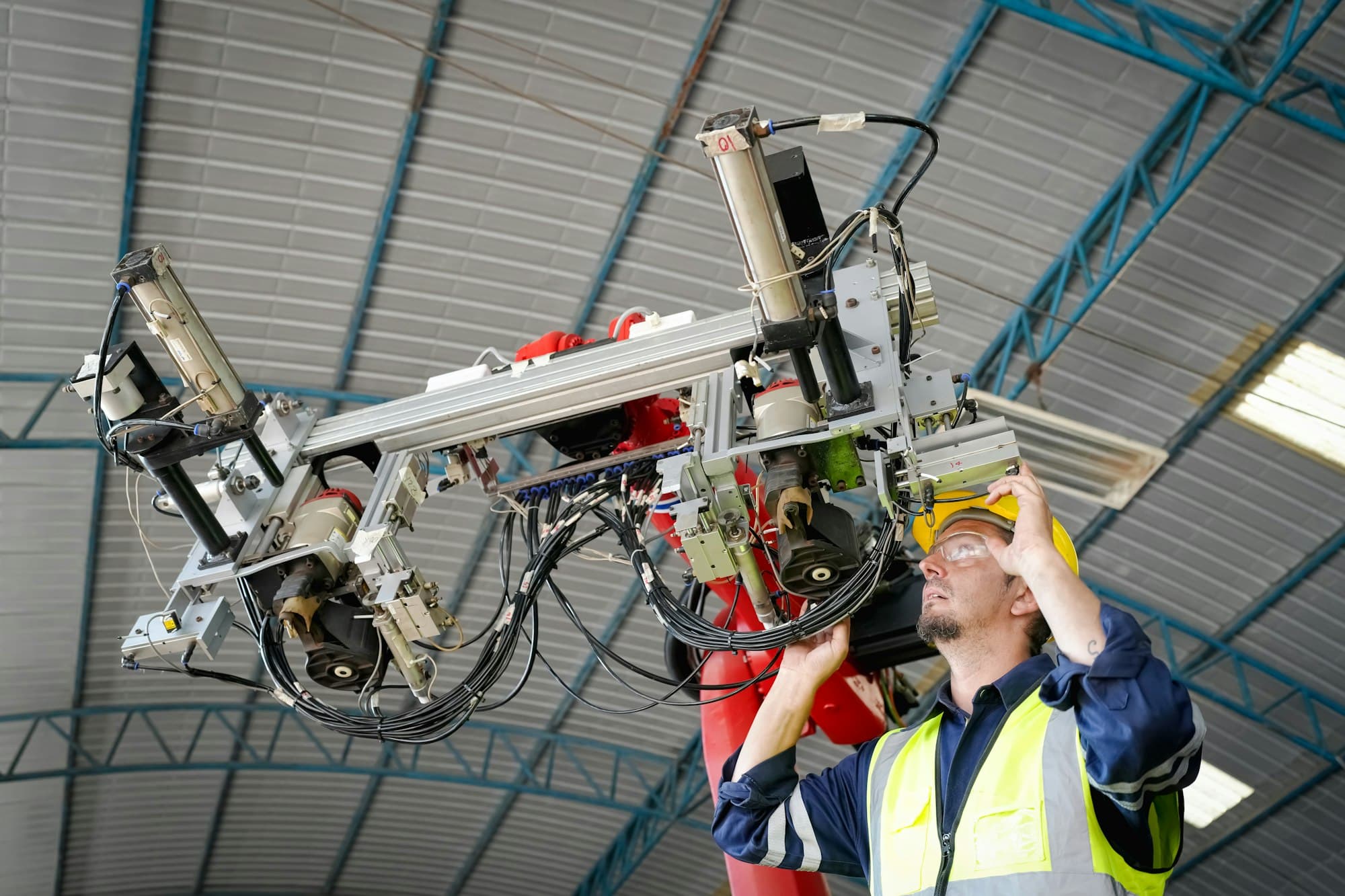 Industrial engineers working at automated AI robotic production factory - New tech industry.